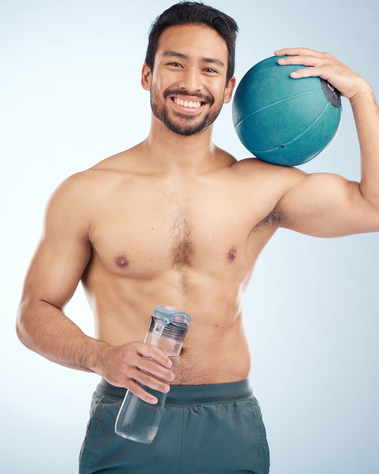 Fit man with medicine ball and water bottle