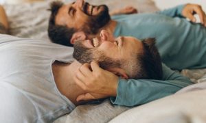 Two men laughing together - rising above self-hatred and building self-compassion