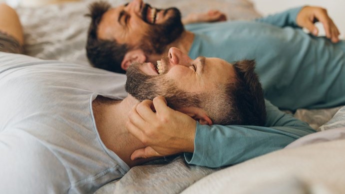 Two men laughing together - rising above self-hatred and building self-compassion