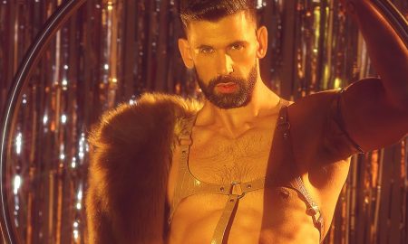 Thomas Worrell in aerial hoop wearing leather harness and fur stole, photographed by Christian Scott for DNA Magazine #297