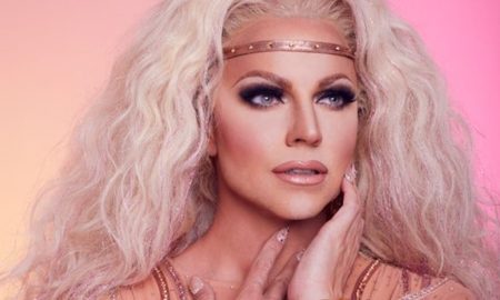 Courtney Act, Sydney showgirl and international reality TV star, poses in a sequinned gown against a pink background