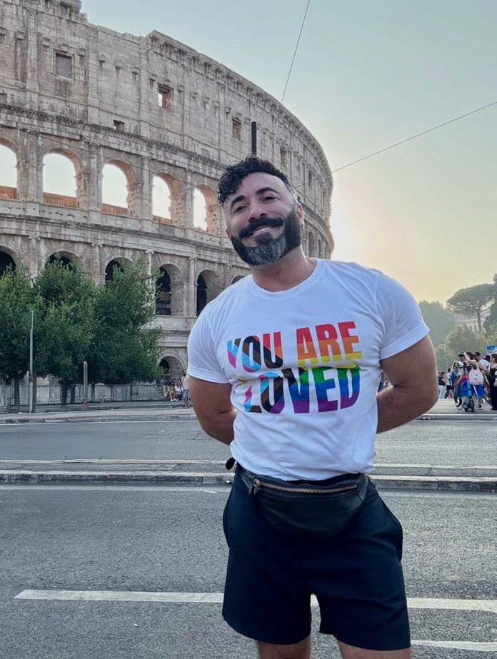 Davide wearing a You Are Loved T-shirt in front of the Colosseum in Rome
