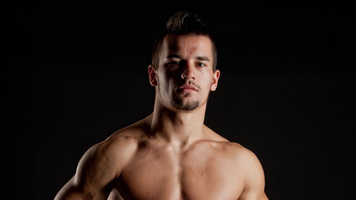 A fit man posing - illustrating health and body wellness for DNA Magazine