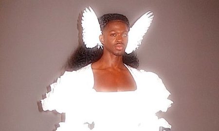 Lil Nas X wearing angel wings and holding rifles for his single J Christ