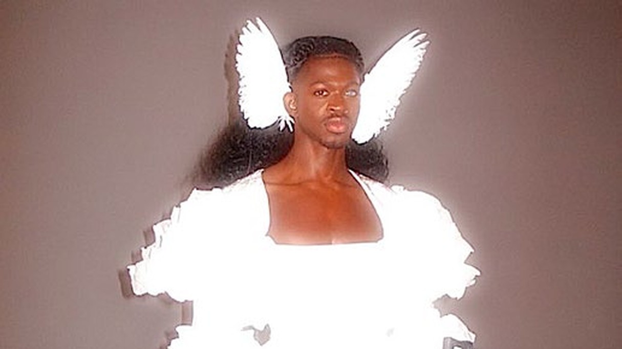 Lil Nas X wearing angel wings and holding rifles for his single J Christ