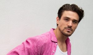 Matthew Hearne, actor and Paralympic athlete, wearing a pink linen shirt