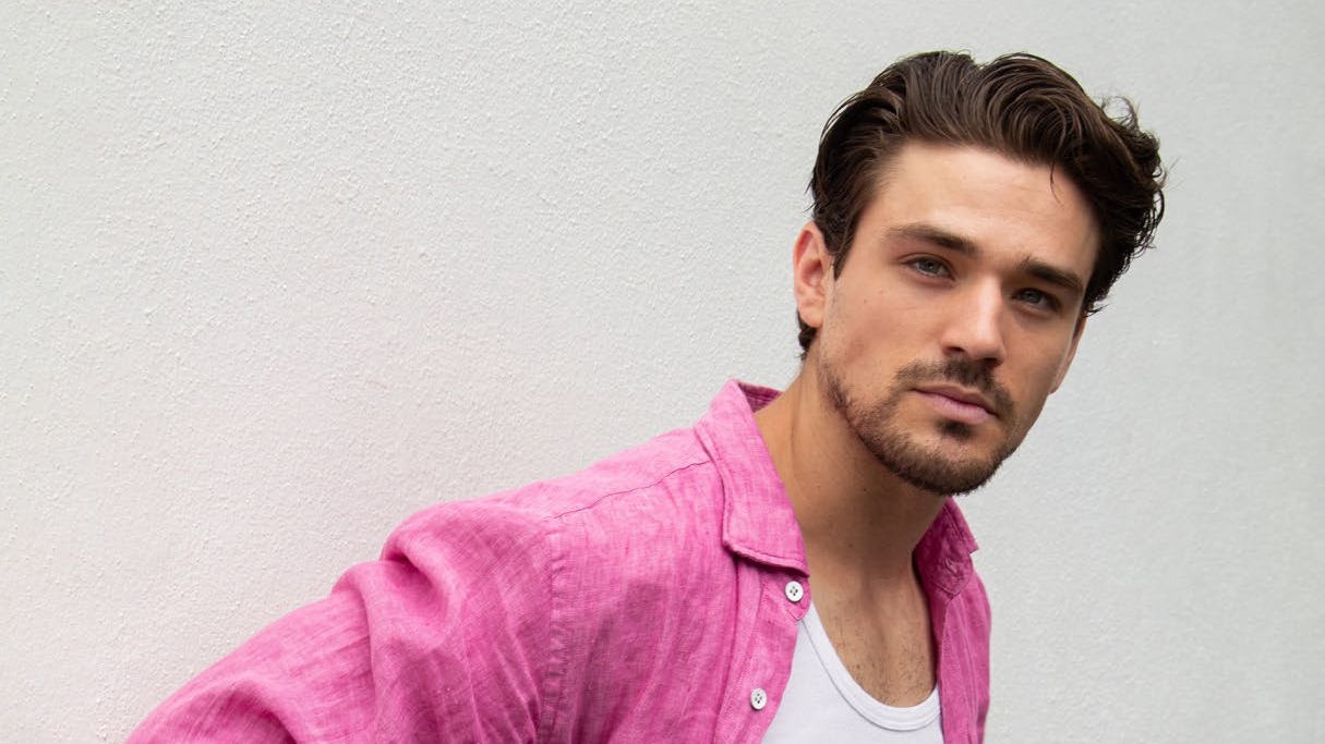 Matthew Hearne, actor and Paralympic athlete, wearing a pink linen shirt