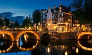 Amsterdam canal at night, host city of WorldPride 2026