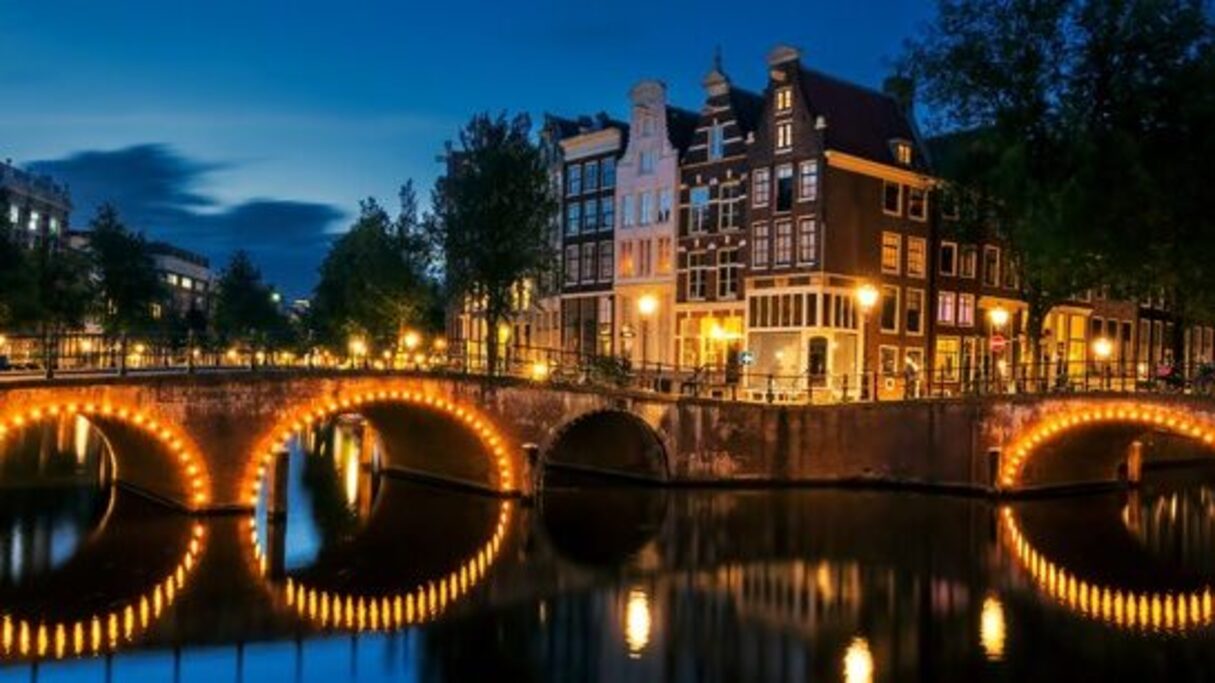 Amsterdam canal at night, host city of WorldPride 2026