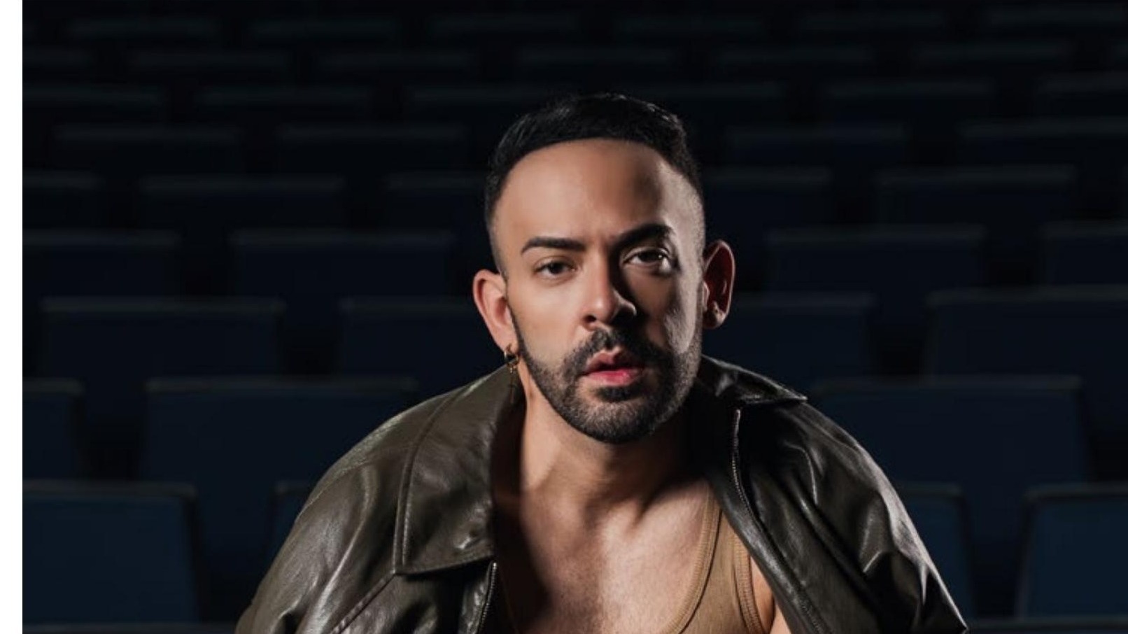 Jose Alfredo, Puerto Rican singer-songwriter, in a leather jacket in an empty theatre